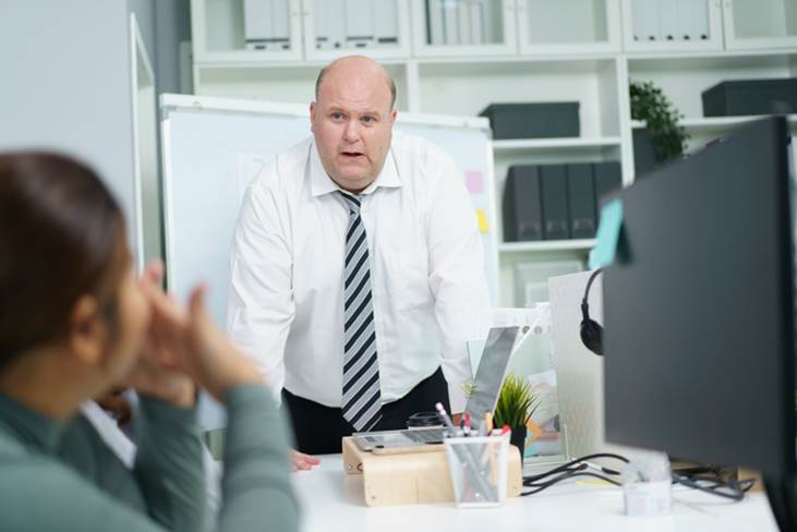 Man talking down to female coworker - Whistleblower Protection